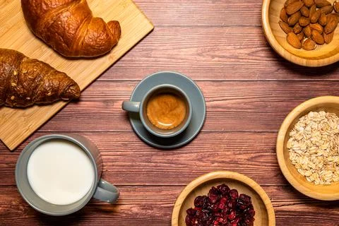 Breakfast table with a cup of espresso coffee in the center Stock Photos