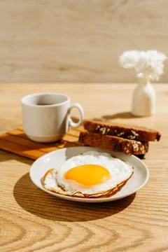 Breakfast is on the table. A cup of tea. Fried egg and toast bread Stock Photos