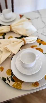 Breakfast table decorated with white cup and napkins Stock Photos
