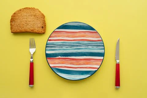 Breakfast table empty colorful plate, toasted bread on yellow background. red Stock Photos