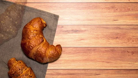 Breakfast table with espresso, milk and croissants of various flavors. Stock Footage 202125798