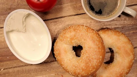 Breakfast table with fresh bagels and cream cheese 스톡 동영상 151059065
