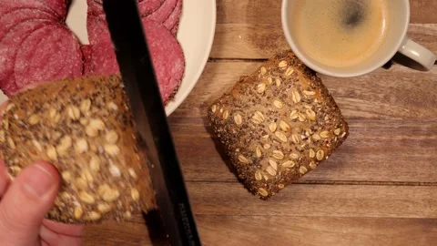 Breakfast table with fresh bread rolls and sausage - top down view 動画素材 151059183