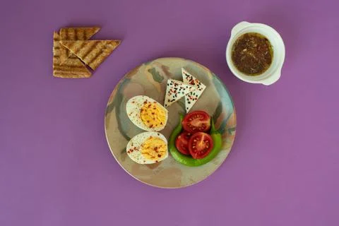 Breakfast table hard boiled egg on colorful plate with toasted bread sliced t Stock-Fotos