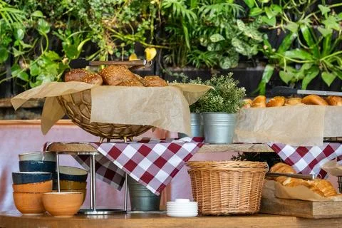 A breakfast table in hotel with a variety of breads and pastries, including.. Stock Photos