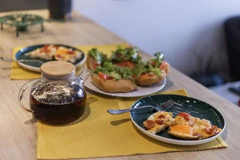 Breakfast table with iced tea and open face sandwiches Stock Photos