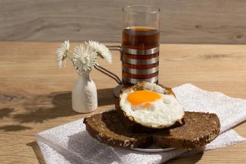 Breakfast is on the table. Kettle with tea and fried eggs on a plate Stock Photos