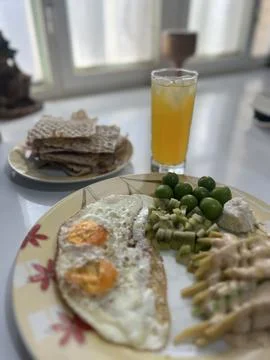 Breakfast Table with Orange Juice Flatbread and Dish Close Up Stock Photos