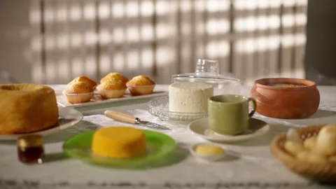 Breakfast Table with Plates, Cuscuz, Steam, and Cakes Stock Footage 303519104