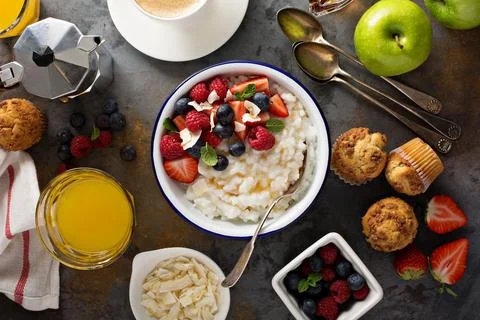 Breakfast table with rice pudding, fruit and muffins Stock Photos