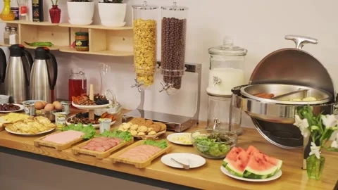 A breakfast table is set in a small hotel. Sausages, yogurt, salads, sauces Stock Footage 255766833
