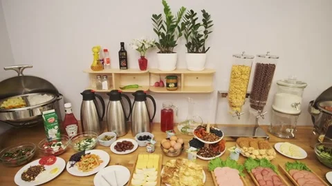 A breakfast table is set in a small hotel. Sausages, yogurt, salads, sauces Stock Footage 310315107