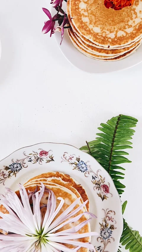 Breakfast table setting with flowers, stack of pancakes, table setting, Stock Footage 227404840
