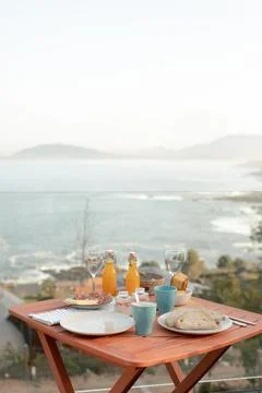 Breakfast table setup with sea view. Outdoor dining photography with copy s.. Stock Photos
