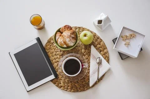 Breakfast table with tablet for news Stock Photos