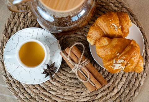 Breakfast Table with Tea, Croissants and Teapot Stock Photos