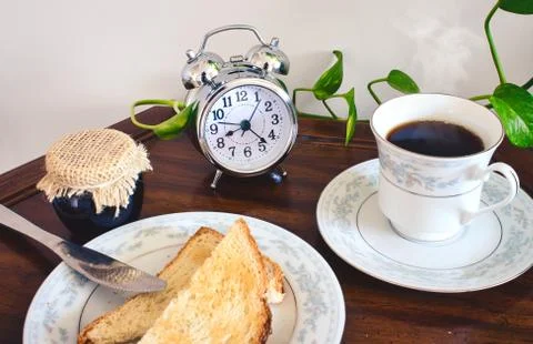 Breakfast table with tea or coffee in a dainty cup and saucer Stock Photos