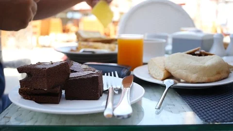Breakfast at a table with white dishes, with a delicious omelet and pastries. HD Stock Footage 96612077