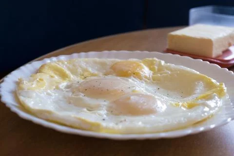 Breakfast on the table.Fried eggs in a plate on the table. Stock Photos