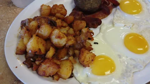 Breakfast three eggs biscuits and gravy sausage toast potatoes Stock Footage 214145603