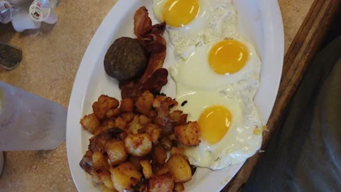 Breakfast three eggs sausage potatoes close up hungry morning Stock Footage 214145729
