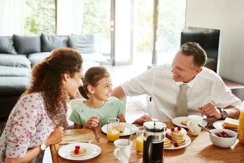 Breakfast time equals quality time. a family having breakfast together at home. Stock Photos