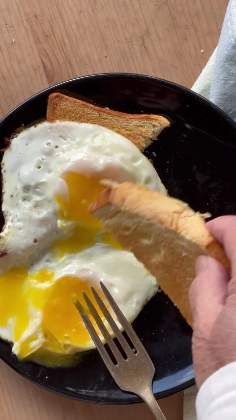 Breakfast toast with runny egg vertical Stock Footage 223185625