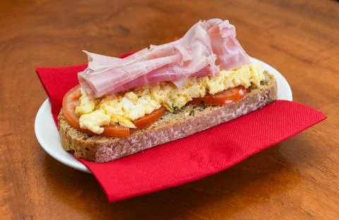 Breakfast Toast with Scrambled Eggs, Ham, and Tomato Stock Photos