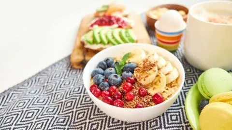 Breakfast top view isolate white background. oatmeal with berries, toasts on a Stock-Fotos