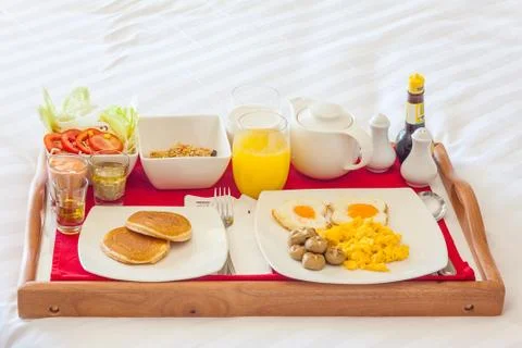 Breakfast in tray on bed Stock Photos