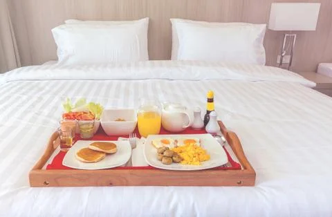 Breakfast in tray on bed Stock Photos