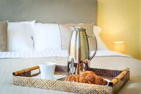 Breakfast tray is on the bed. Stock Photos