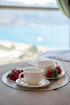 Breakfast tray is on the bed. Stock Photos