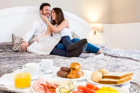 Breakfast tray with couple in background. Stock Photos