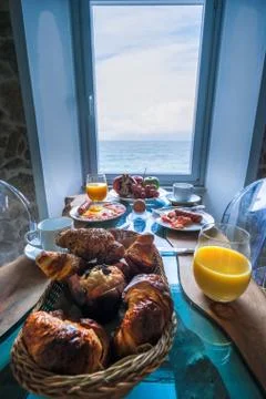 Breakfast with a view over the ocean from the window, Cefalu, medieval village Stock Photos