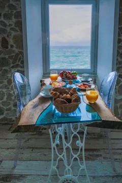 Breakfast with a view over the ocean from the window, Cefalu, medieval village Stock Photos