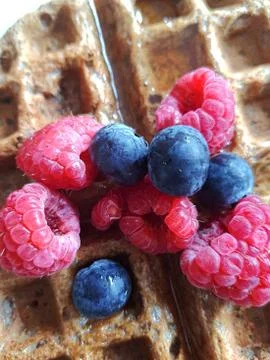 Breakfast waffle topped with fresh berries and honey  Stock Photos