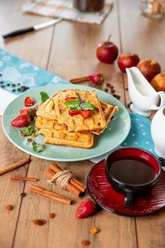 Breakfast with waffles, strawberries, mint and cinnamon Stock Photos