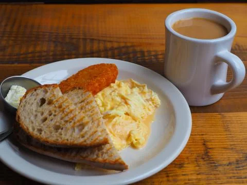 Breakfast of wet soft scrambled eggs. Stock Photos