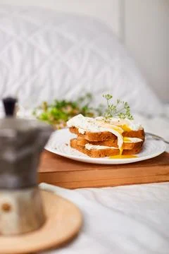 Breakfast on white bed sheets, good morning, toast with poached eggs, coffee Stock Photos