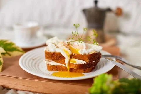 Breakfast on white bed sheets, good morning, toast with poached eggs, coffee Stock Photos