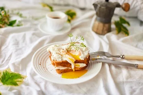 Breakfast on white bed sheets, good morning, toast with poached eggs, coffee Stock Photos