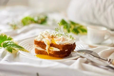 Breakfast on white bed sheets, good morning, toast with poached eggs, coffee Stock Photos