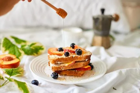 Breakfast on white bed sheets, good morning, summer french toast Stock Photos