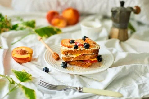 Breakfast on white bed sheets, good morning, summer french toast Stock Photos