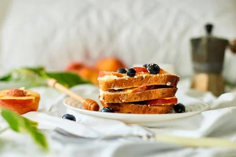 Breakfast on white bed sheets, good morning, summer french toast Stock Photos