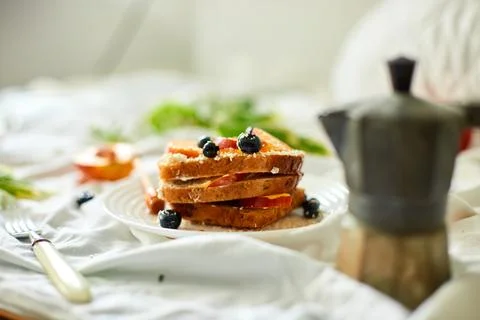 Breakfast on white bed sheets, good morning, summer french toast Stock Photos