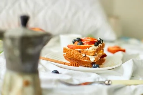 Breakfast on white bed sheets, good morning, summer french toast Stock Photos