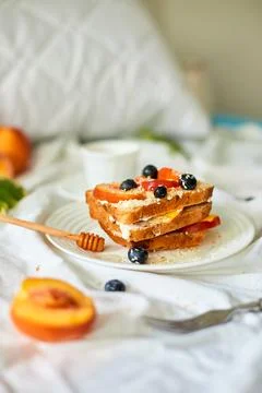 Breakfast on white bed sheets, good morning, summer french toast Stock Photos