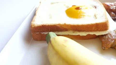 Breakfast,Include,pork steak,Fried egg, bread and banana Stock Footage 70114482